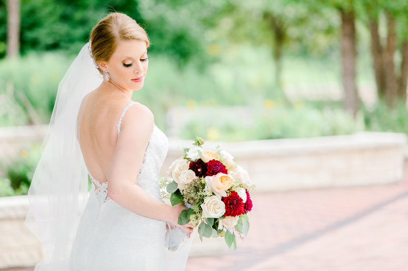 bride looking to the back holding floers