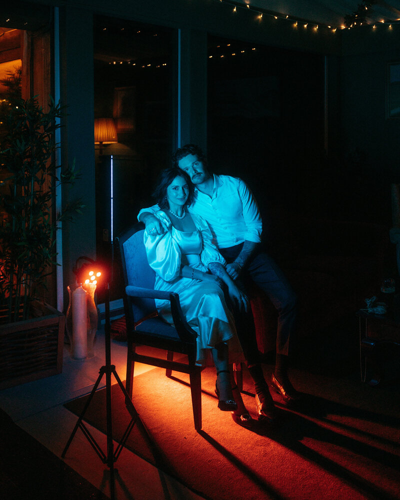 blue and orange light portrait of young chic bride and groom