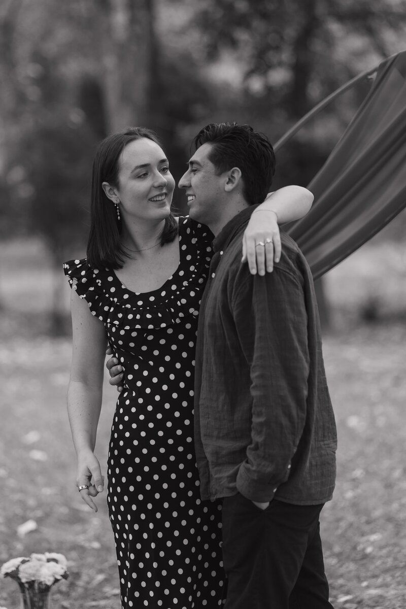 Couple hugging after proposal in Marietta.