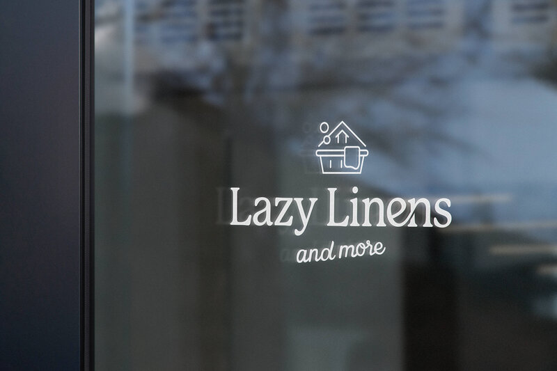 Modern logo design for Lazy Linens on store window, crafted for cozy lifestyle brands by a creative brand designer.