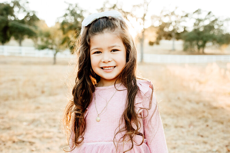 Upclose portrait of a smiling little girl for her family photography session in San Luis Obispo. 