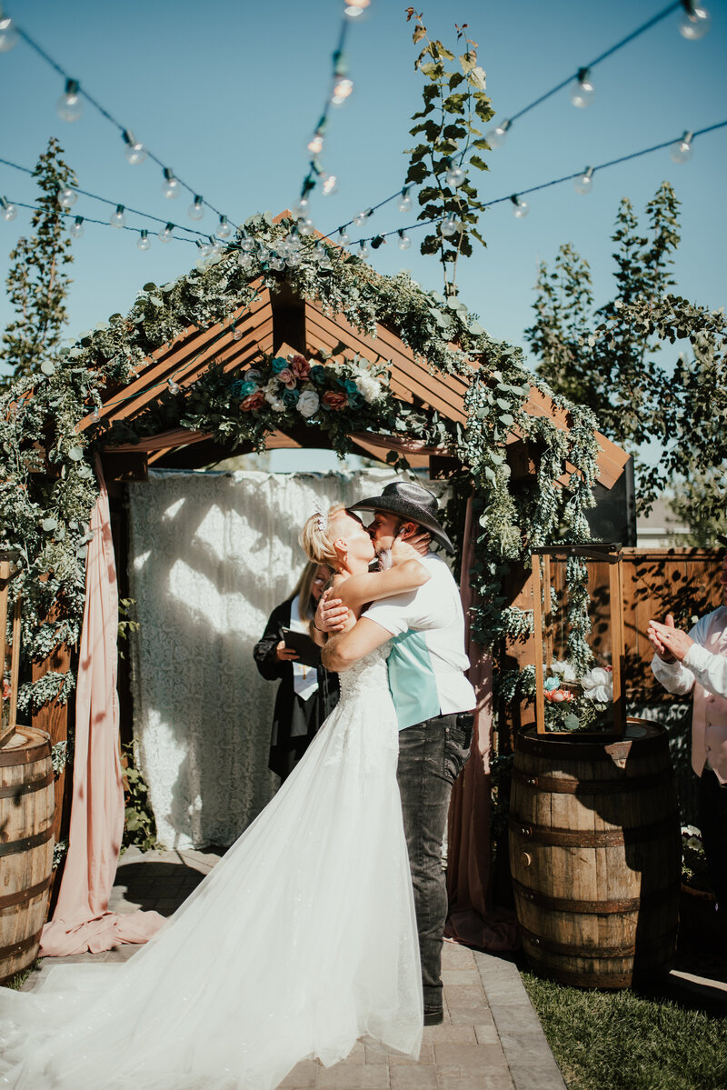 Beautiful couple kissing during their Idaho wedding ceremony
