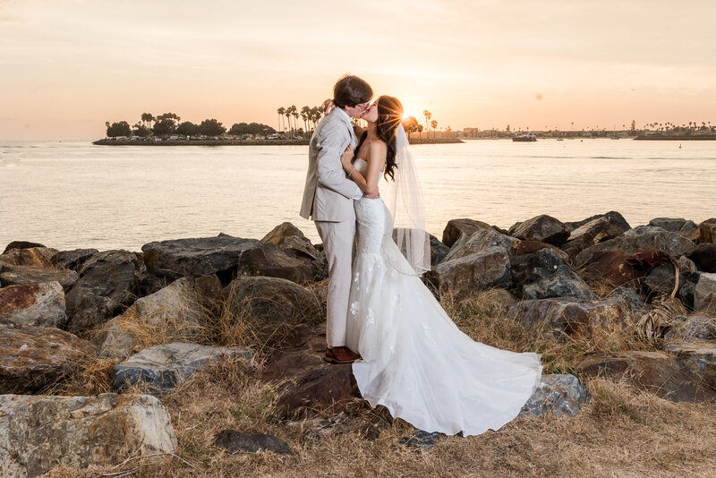 bride and groom walking on the beach at their Catamaran Resort San Diego wedding