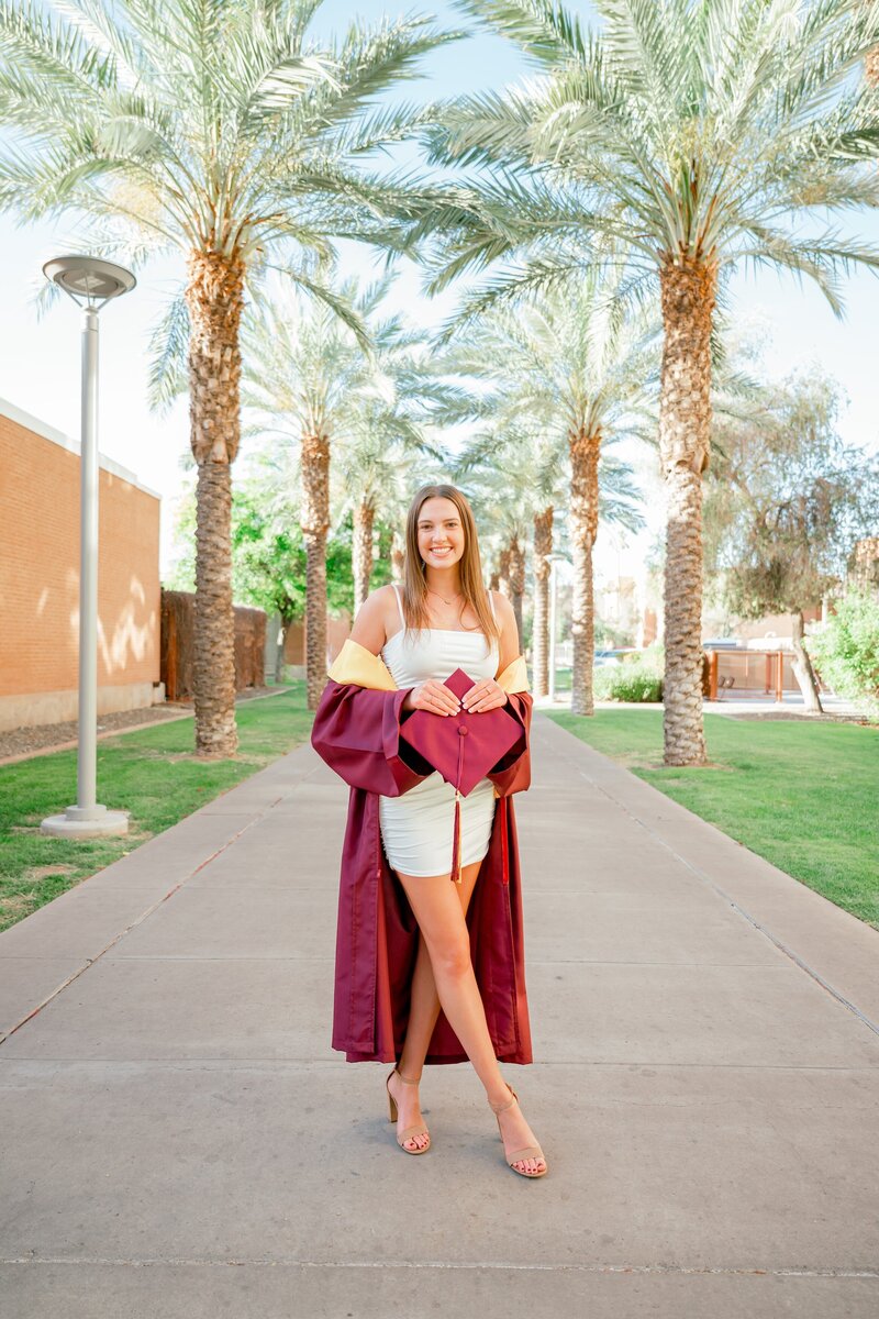 ASU graduate posing on palm wallk for her senior photos