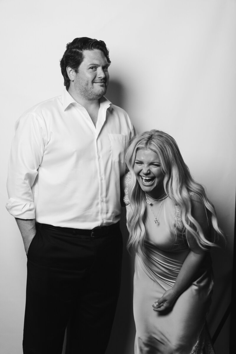 Laughing wedding guest couple captured during The Portrait Parlour guest portrait experience at a Cleveland Ohio wedding.