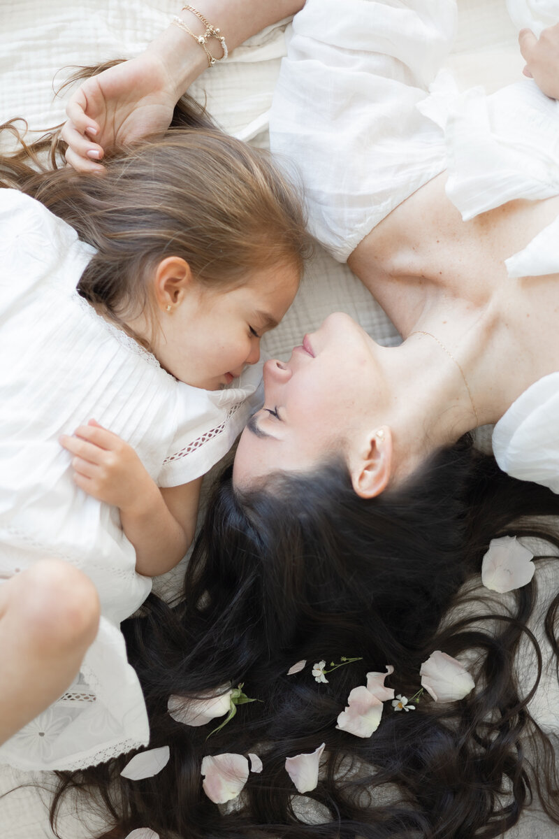 mom and daughter face to face with rose petals studio session in Miami - Sandra Vallejo Photography