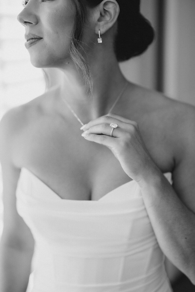 Bride holds necklace with engagement ring hand at wedding in Athens Georgia