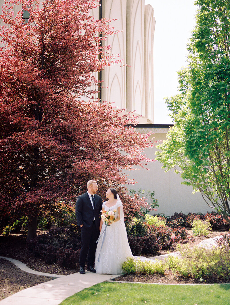 Bride and Groom laughing at Provo, Utah Temple