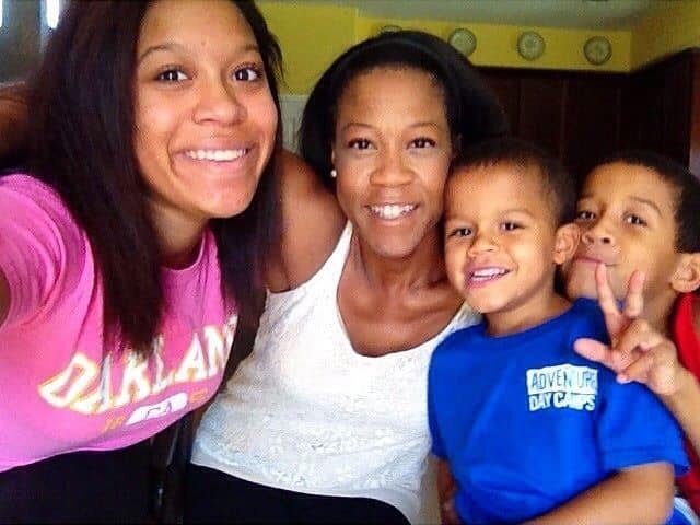 Candid street photo of woman in sunglasses and blazer walking downtown