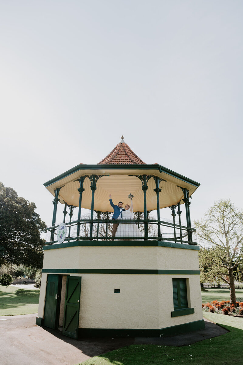 Wedding reception Long rectangle tables styled with candles and white rose bud vases at the Warrnambool Golf Club