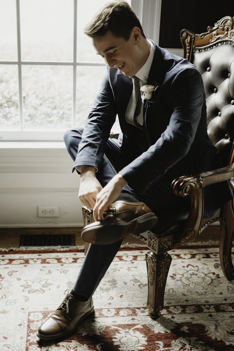Groom fixing his shoes
