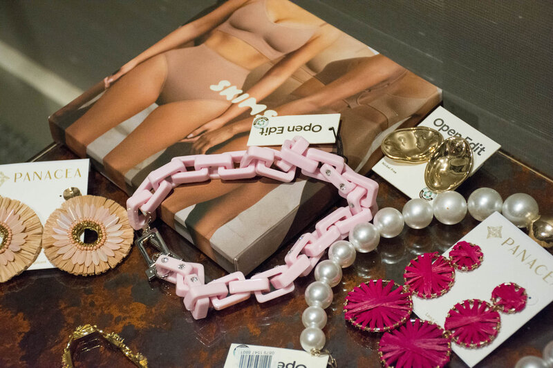 Necklace, earrings and shape wear on a table