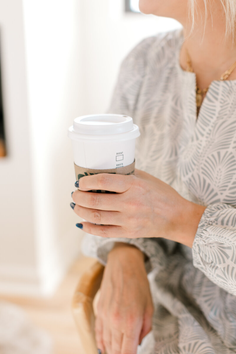 Sarah Kaetterhenry reading email and drinking Starbucks Refresher at home