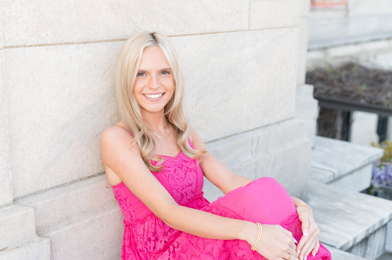 girl in pink dress at cleveland museum of art for senior portrait session