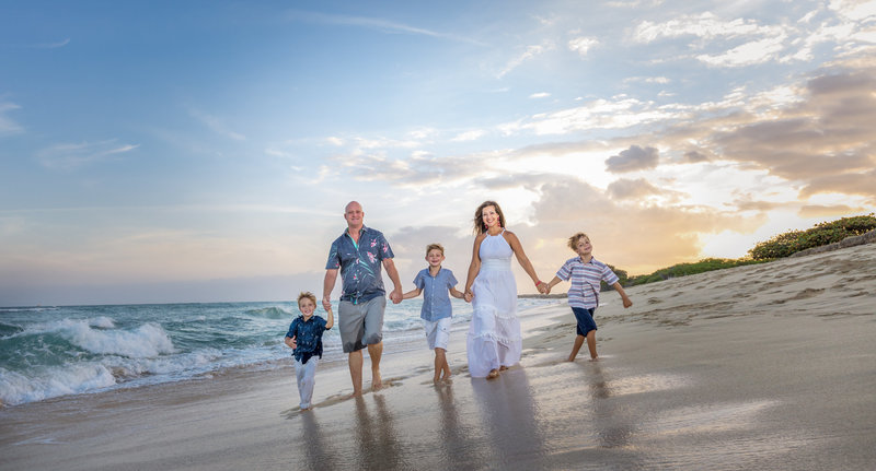 Family walking along beach in Texas