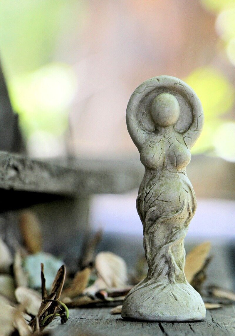 Goddess statue with arms raised next to quote about being seen