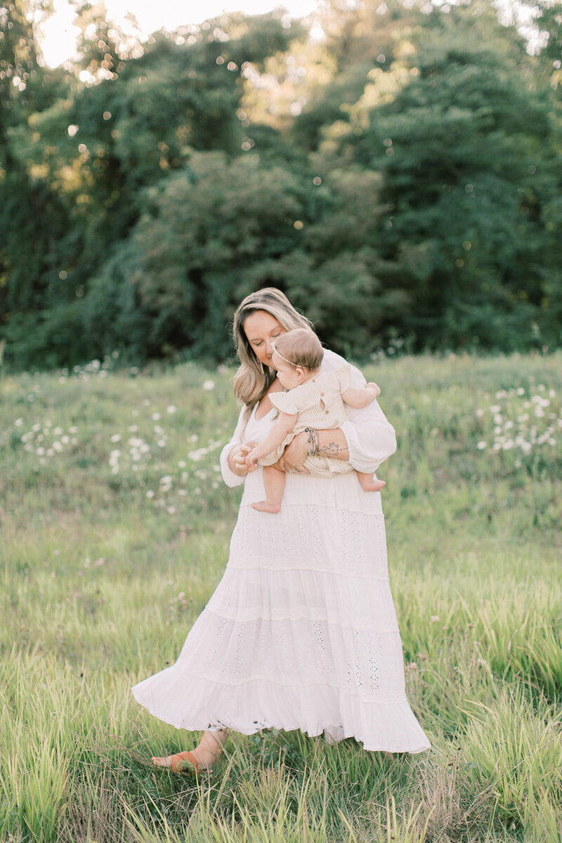 Woman holds baby in golden-hour field outside of Mechanicsburg, PA