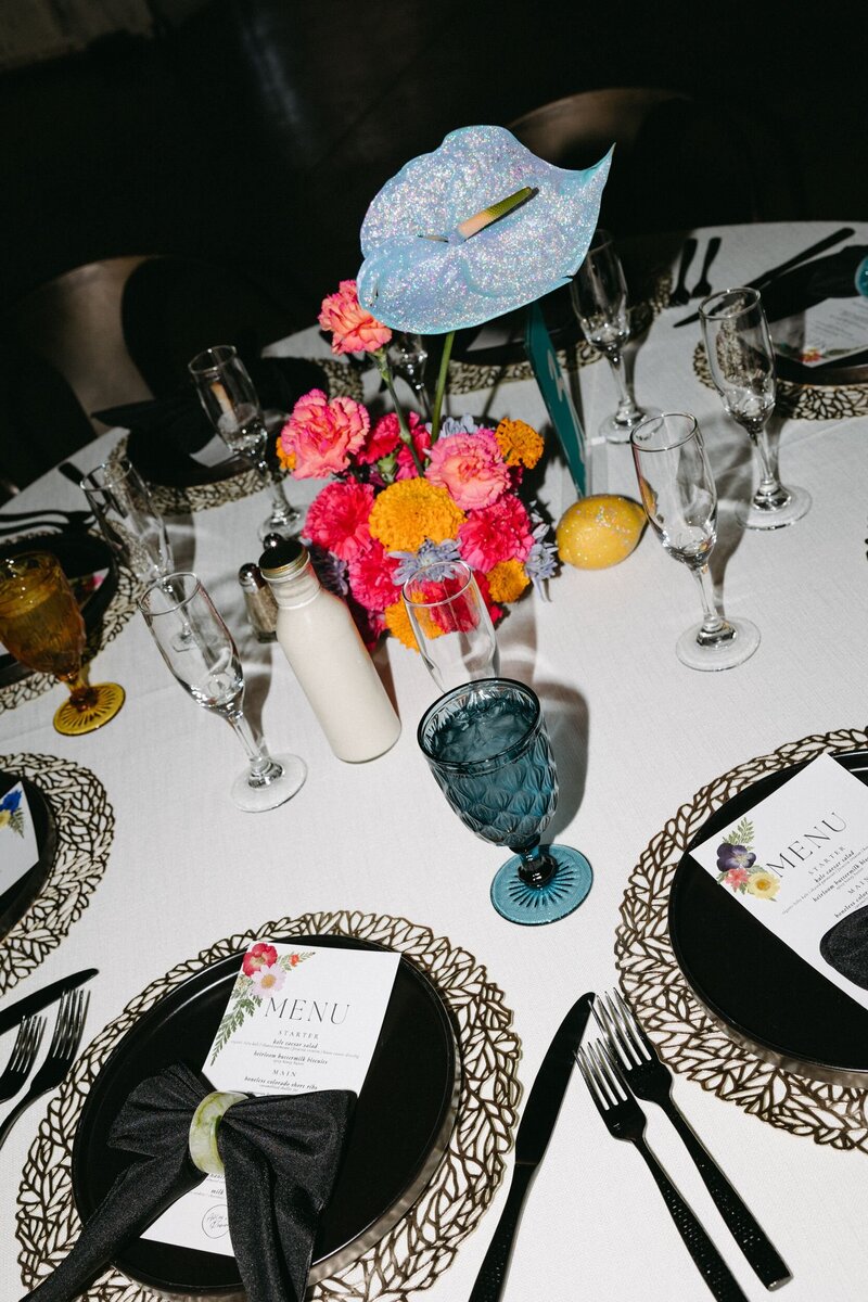 A woman with her arms outstretched holding red streamers.