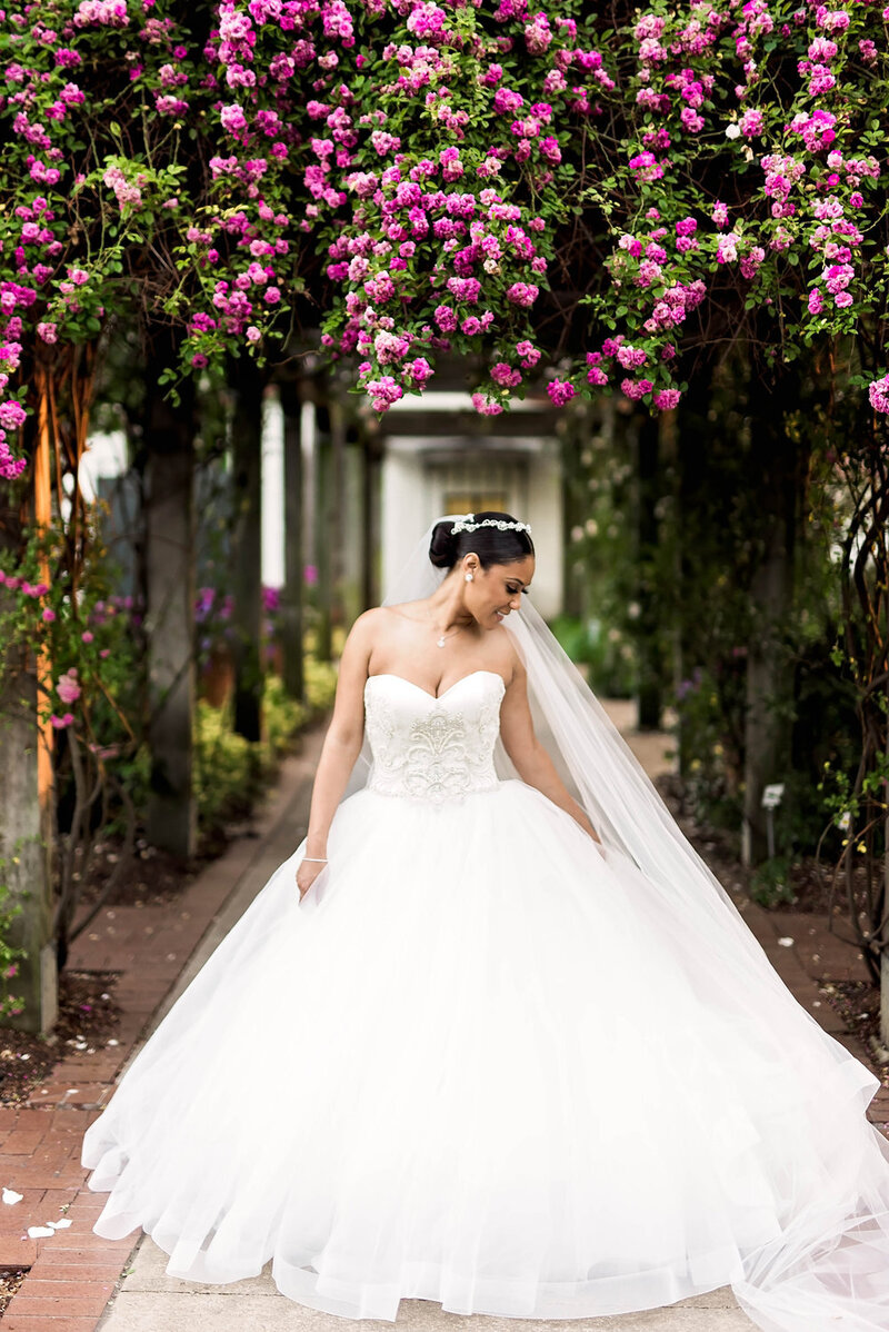 Swank Soiree Dallas Wedding Planner Kerri and Bravion at the Dallas Arboretum and Botanical Garden - Bride in front of pink flowers