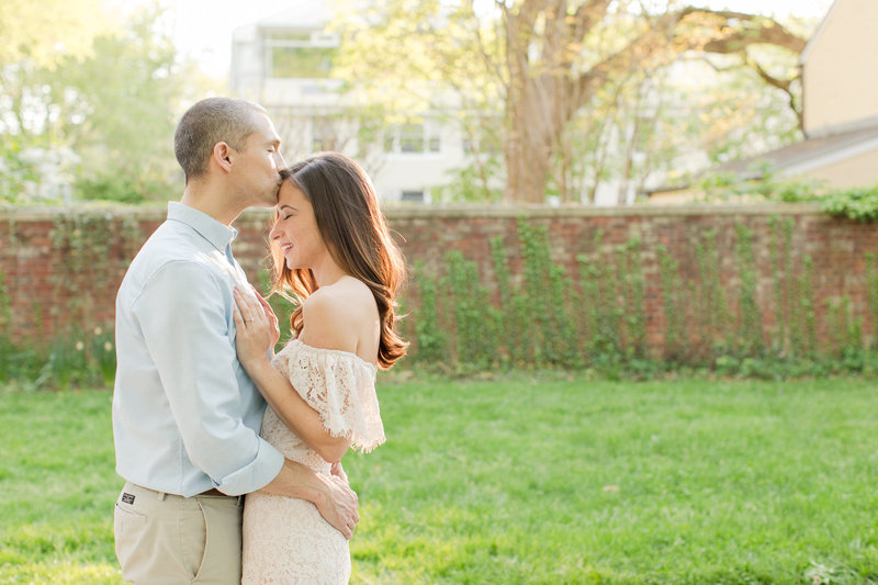 bride and groom cuddling at Princeton University during their engagement session