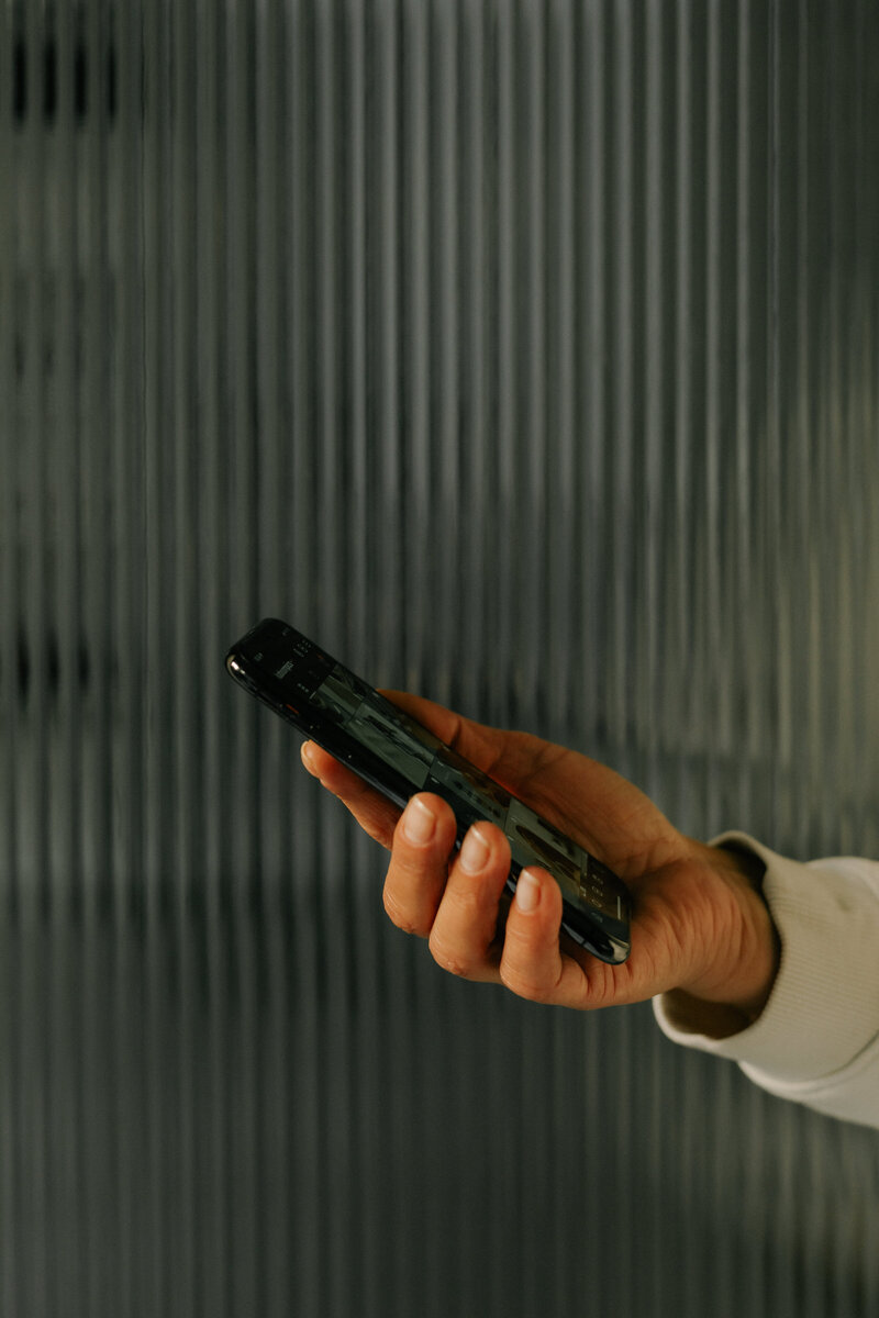 hand holding black iphone