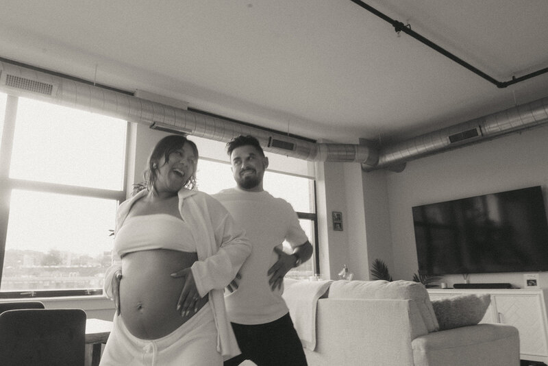 black and white photo of couple dancing during maternity photoshoot captured by NYC maternity photographer Elsie Goodman 