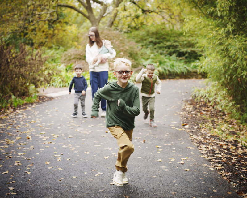Light shining down on parents standing with their three kids.
