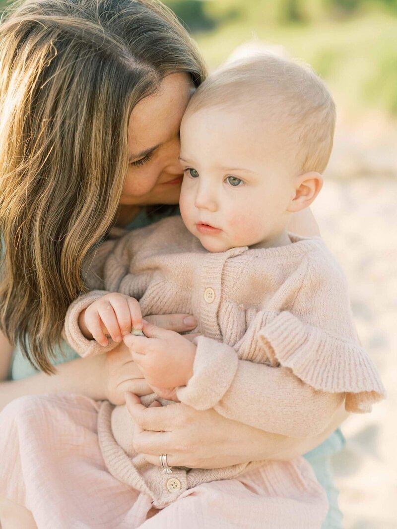 mother and daughter snuggle during session By Carrie Pellerin