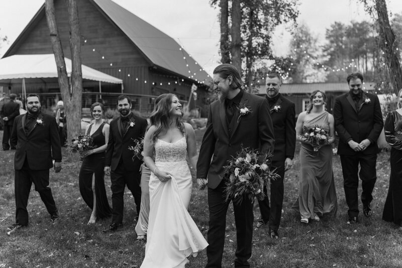 bride and groom walking through path