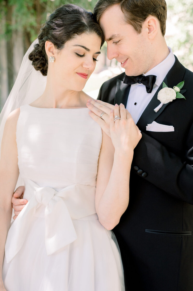bride in a lace dress holding a white flower bouquet