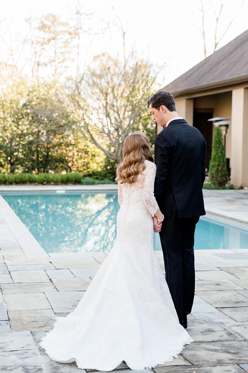 bride-and-groom-standing-by-pool