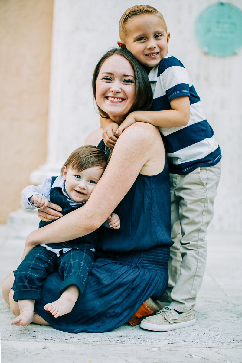 Orlando Medium, Brandi of the Intuitive Momma sits and smiles with two sons, Clay and Liam