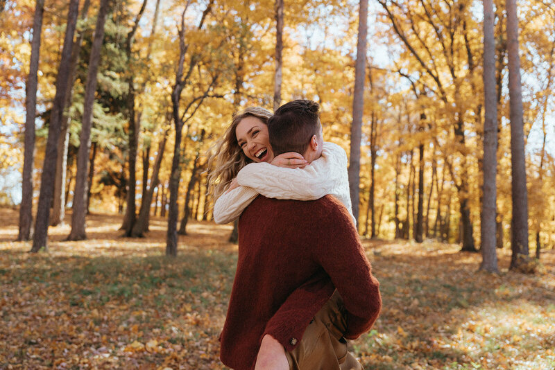 couple with arms around each other during fall engagement photos, captured by Elsie Goodman, an NYC engagement and couples photographer