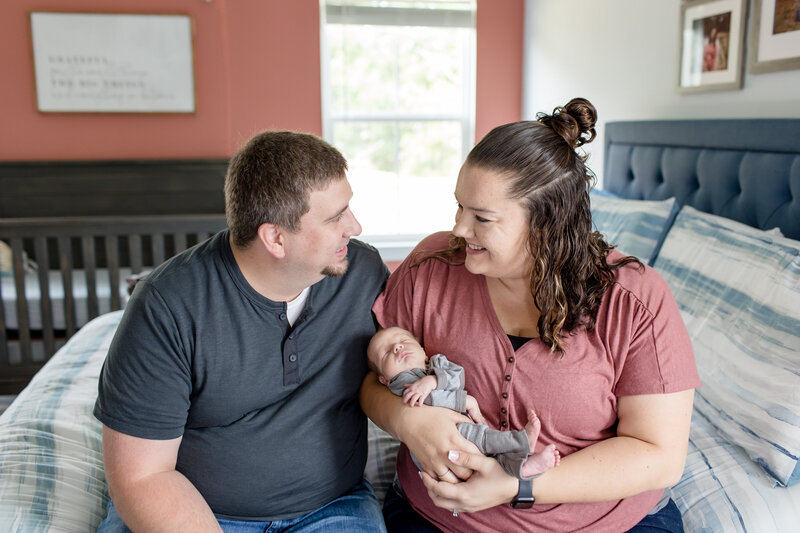 Portrait of Molly Berry with new baby and husband taking by Erin Combs Harper