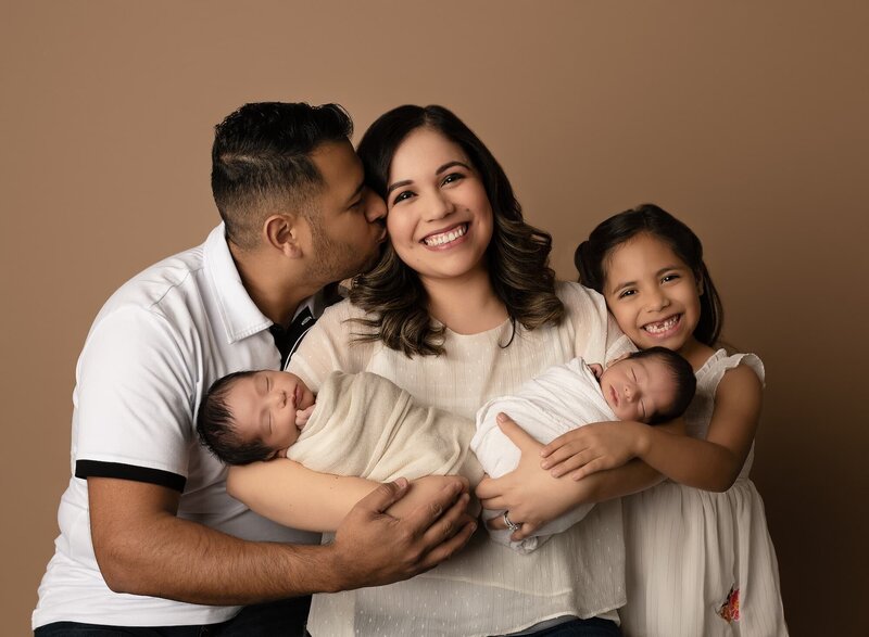 Family of five with newborn twin boys posing for first family photos