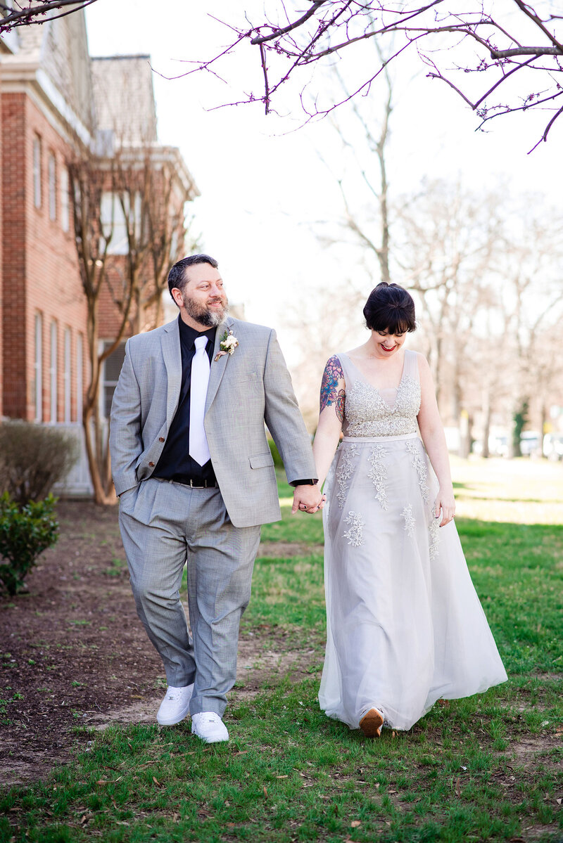 Newlyweds walking together, holding hands, after saying vows at elopement in Nashville