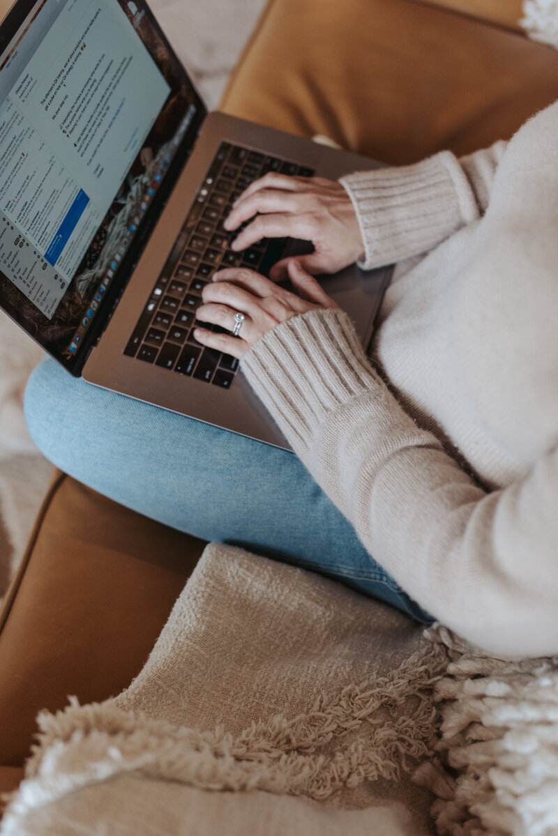 Sarah Kaetterhenry emailing on couch