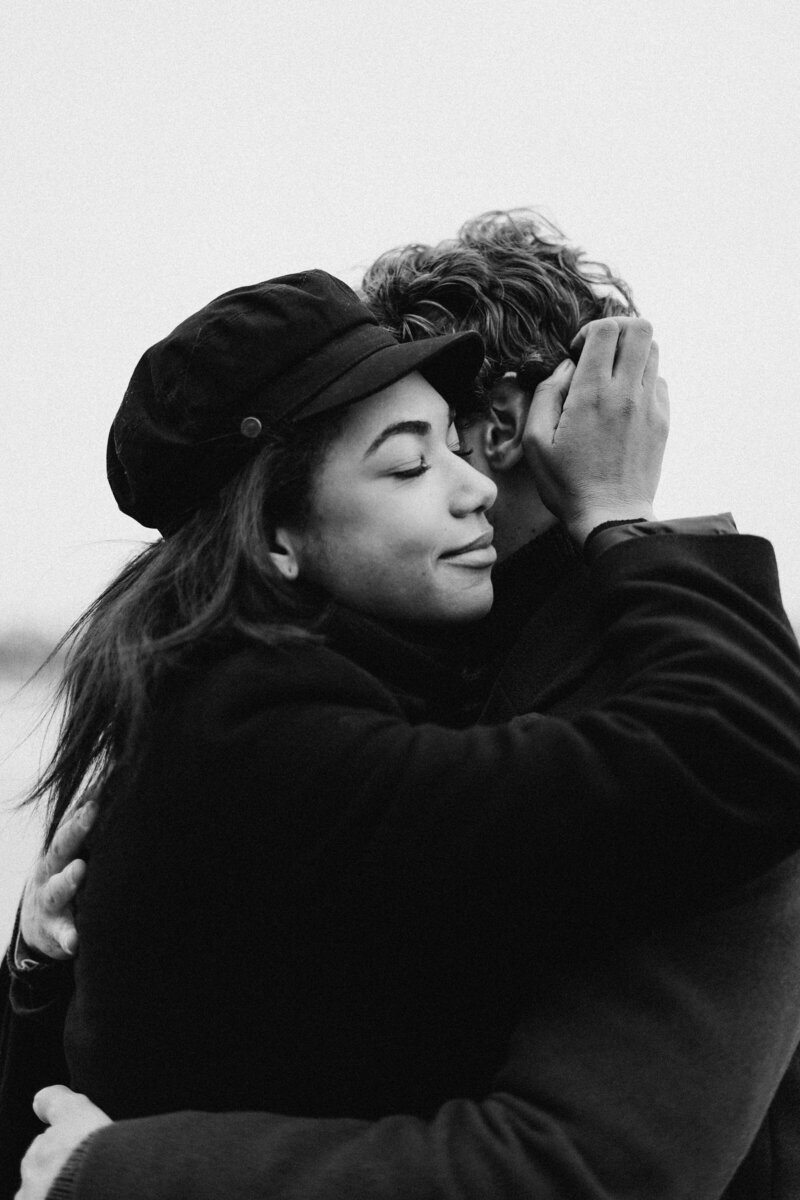 black and white image of man and woman hugging