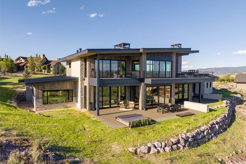 Backyard and exterior of a cozy mountain vacation rental by vacation home interior designer Chalet + Co.