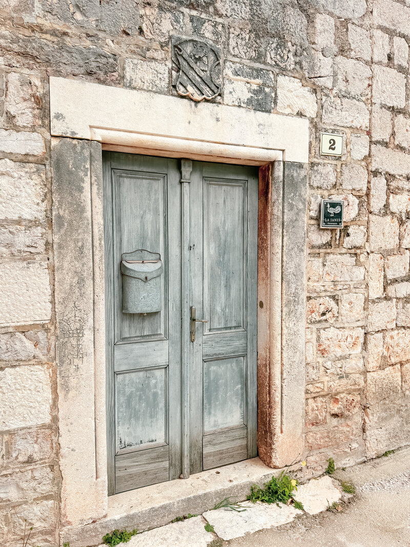 Hvar Island Croatia Starigrad old door with coat of arms above it 