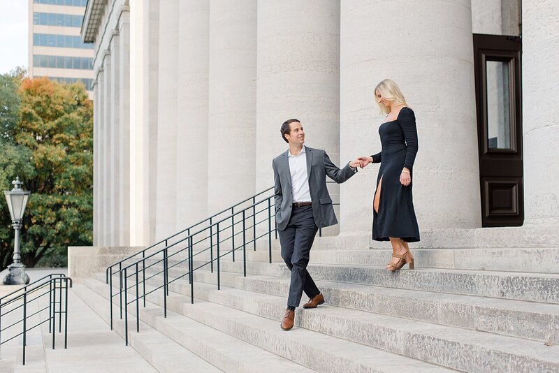 couple walking down the stairs at engagement session at ohio state house
