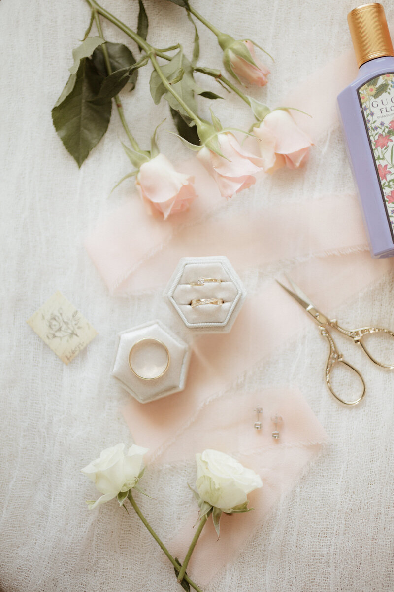 This image is a flat lay of the brides details.