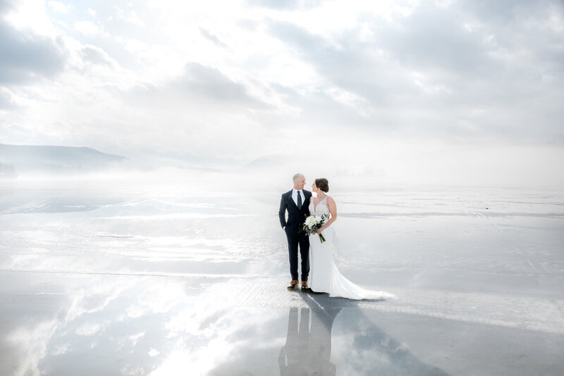 Bride and groom standing on beautiful hazy beach
