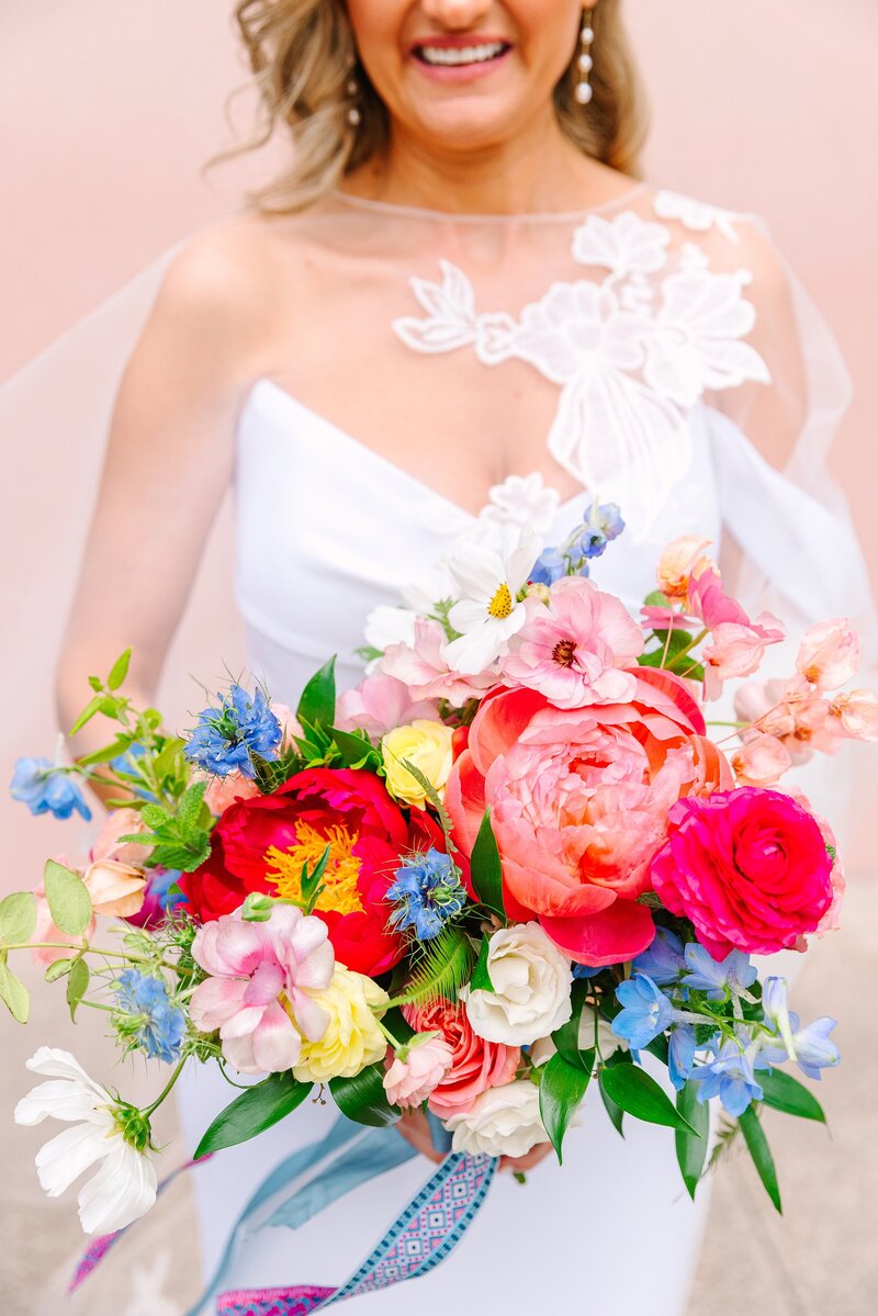 detail photos of a bride holding a colorful bouquet