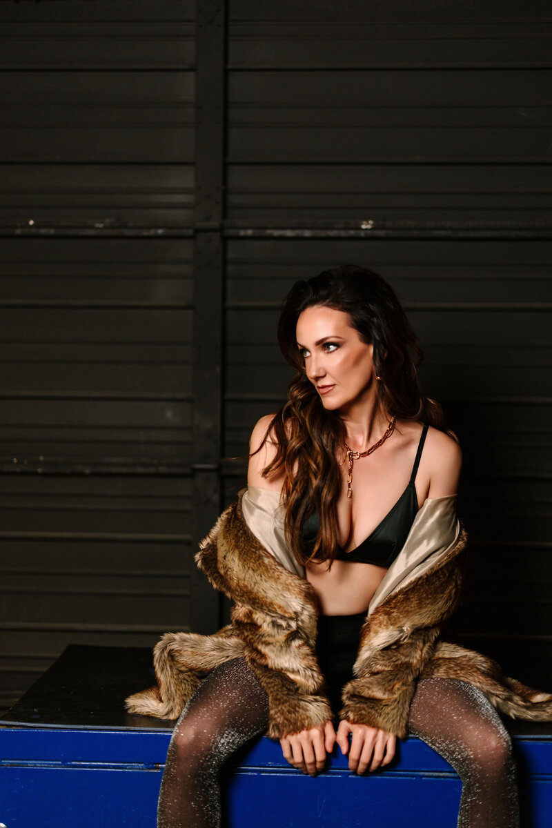 Photo of Juliet Trnka in a fur coat with a dark background