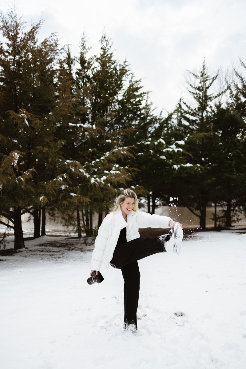 girl in snow with photography camera