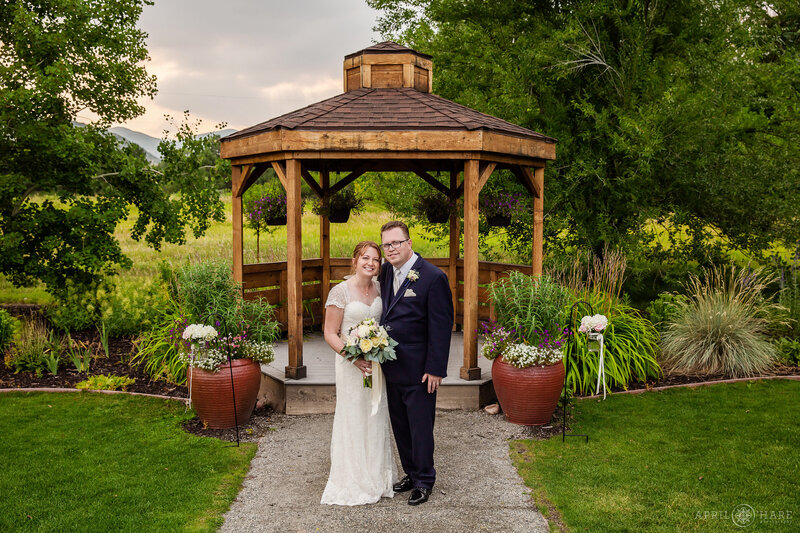 Wedding couple portrait with the wood gazebo at Open Air Chapel at Chatfield Farms Denver Botanic Gardens