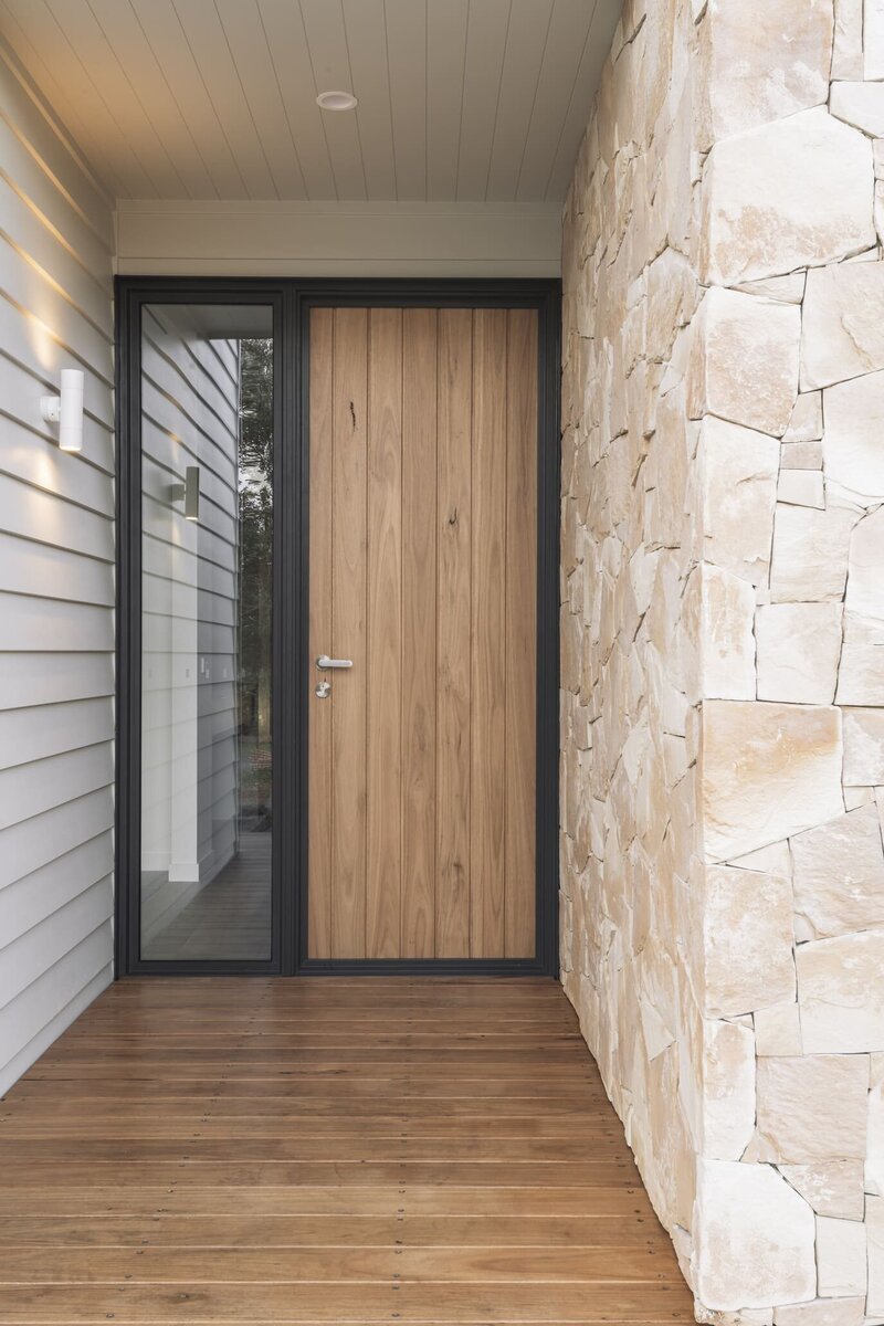 Front wooden foor of a custom home build in Geelong with stone tile pattern on the wall..