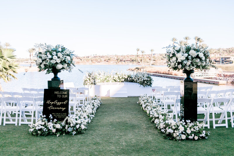 Stunning wedding ceremony set up at Reflection Bay with floral lined aisle
