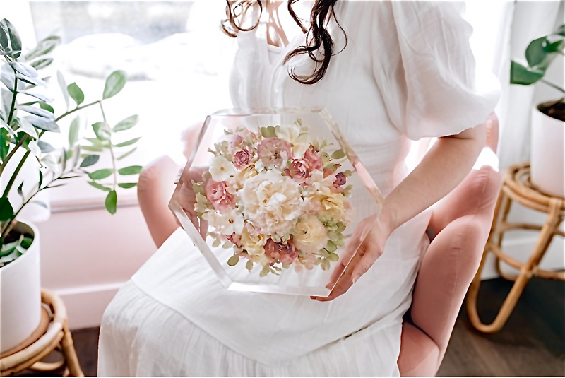 women holding beautifully preserved wedding flowers in a hexagon shaped resin piece